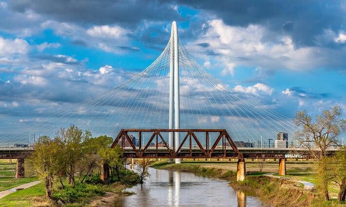 Side view of the Margaret Hunt-Hill Bridge and the Train Bridge in Dallas, TX.